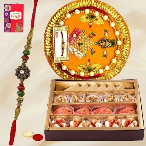 Assorted Sweets and Designer Pooja Thali along Rakhi, Roli, Tilak and Chawal